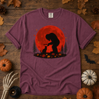 Berry Comfort Colors t-shirt featuring Bigfoot booping a black cat's nose in front of a red autumn moon, with maple leaves and pine trees, Trail & Ember Co.