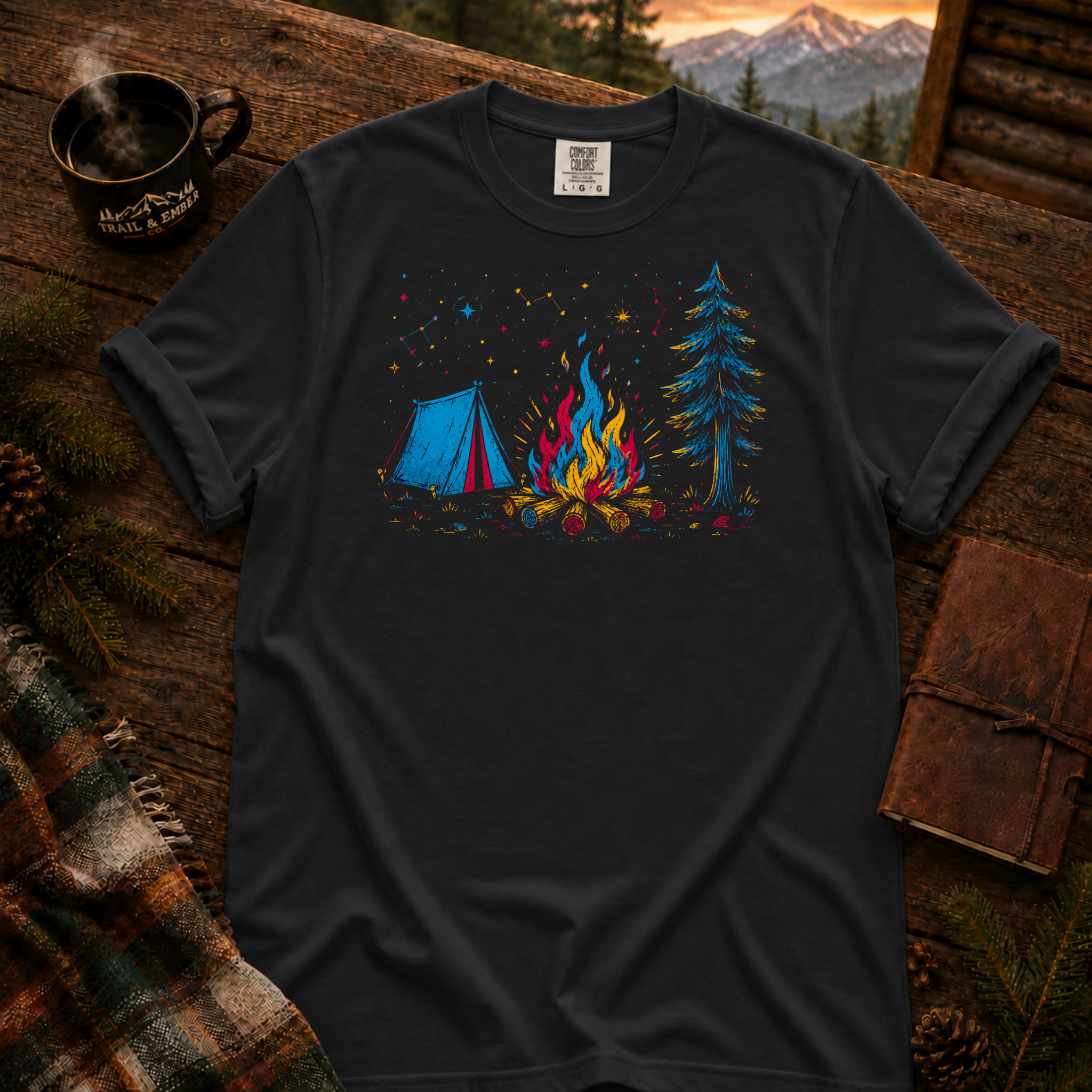 Black Comfort Colors t-shirt with a neon-lit campsite scene — tent, campfire, and stars in layered red, blue, and gold neon linework, Trail & Ember Co.