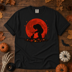 Black Comfort Colors t-shirt featuring Bigfoot booping a black cat's nose in front of a red autumn moon, with maple leaves and pine trees, Trail & Ember Co.