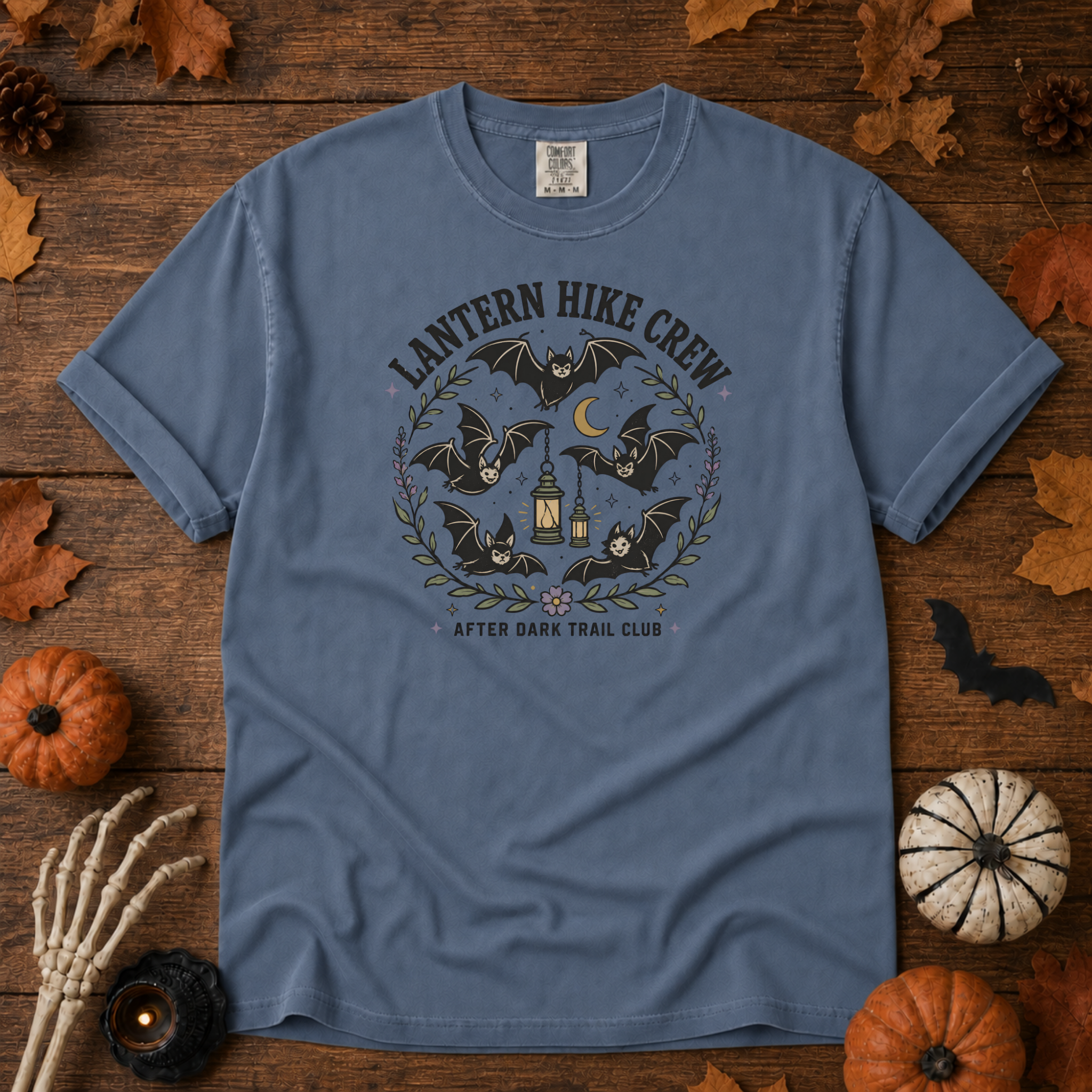Blue Jean Comfort Colors t-shirt featuring a lantern glowing on a switchback trail under the moon, Trail & Ember Co.