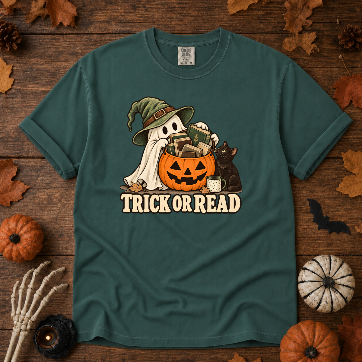 Trick or Read Halloween book lover t-shirt in Blue Spruce - ghost in a witch hat with a pumpkin bucket full of books and a black cat, on garment-dyed Comfort Colors cotton