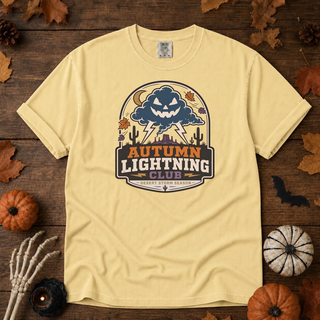 Butter Comfort Colors t-shirt featuring lightning splitting the sky over a lone saguaro with storm clouds rolling across the desert, Trail & Ember Co.