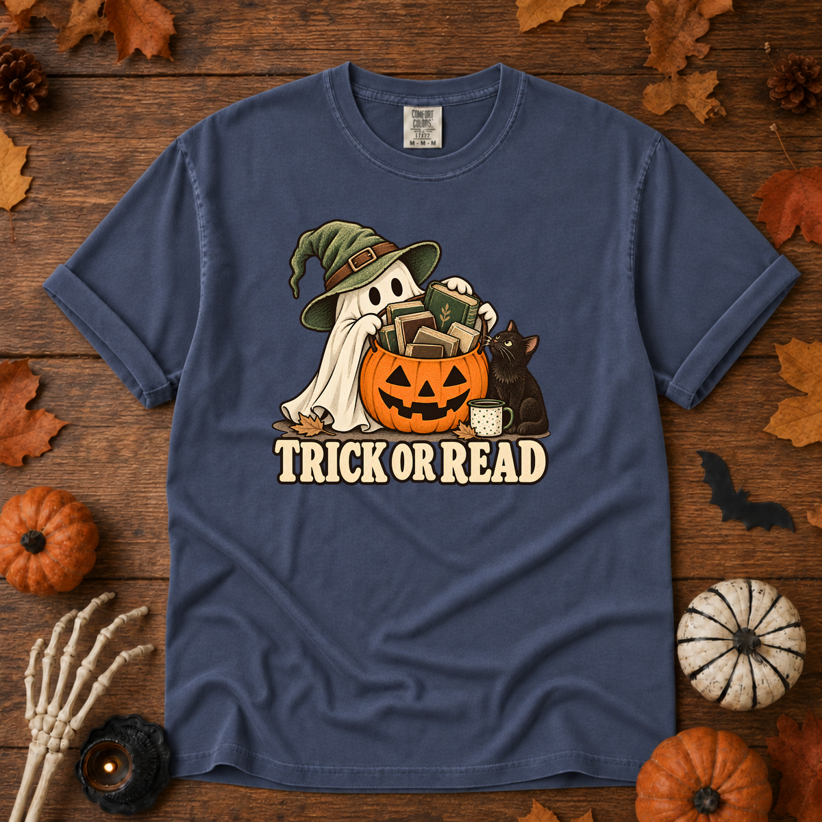 Trick or Read Halloween book lover t-shirt in China Blue - ghost in a witch hat with a pumpkin bucket full of books and a black cat, on garment-dyed Comfort Colors cotton