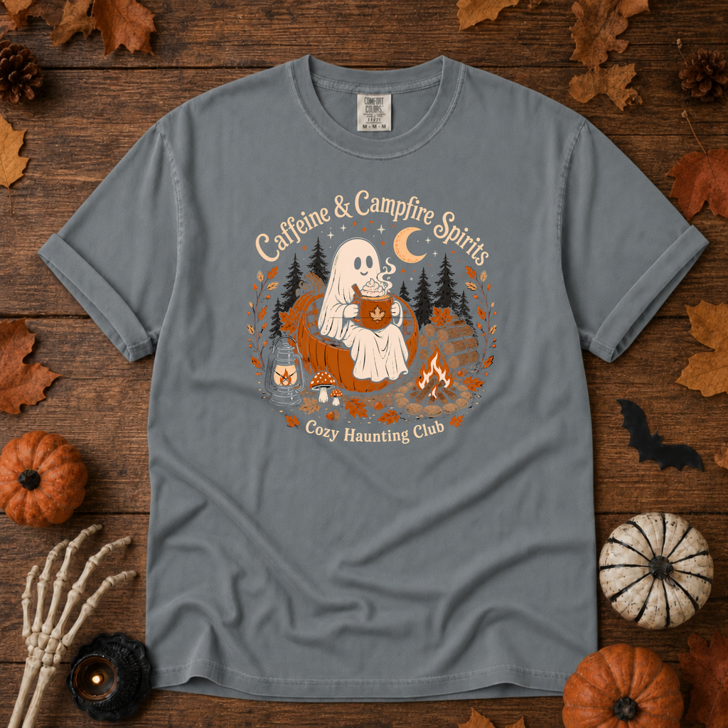 Granite Comfort Colors t-shirt featuring a ghost sitting in a pumpkin chair with a steaming mug of cocoa, campfire, lantern, mushrooms and maple leaves, Trail & Ember Co.