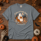 Granite Comfort Colors t-shirt featuring a ghost sitting in a pumpkin chair with a steaming mug of cocoa, campfire, lantern, mushrooms and maple leaves, Trail & Ember Co.