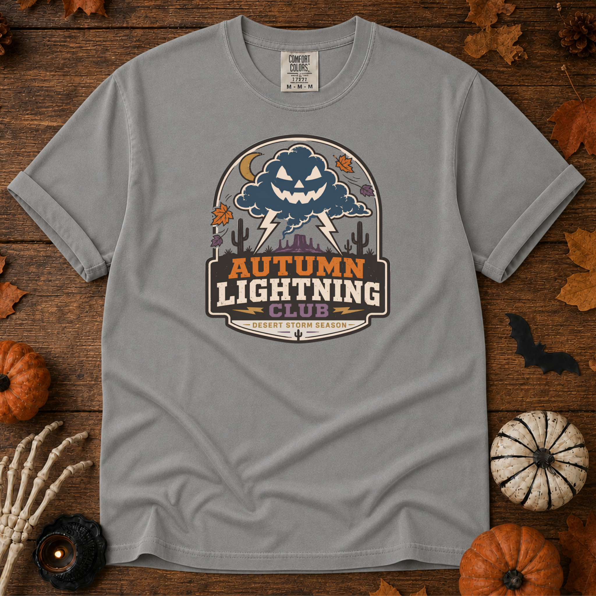 Grey Comfort Colors t-shirt featuring lightning splitting the sky over a lone saguaro with storm clouds rolling across the desert, Trail & Ember Co.
