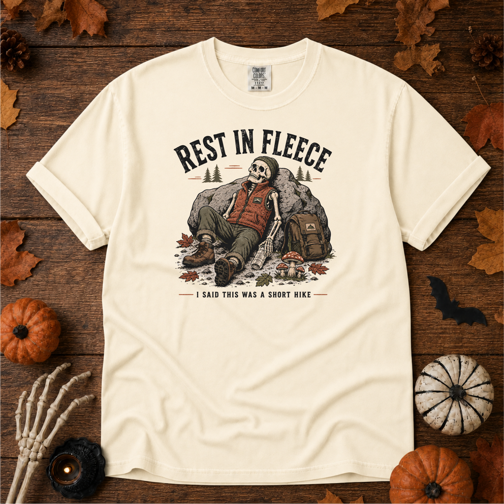 Ivory Comfort Colors t-shirt featuring a skeleton wrapped head to rib in fleece, propped against a lantern, Trail & Ember Co.