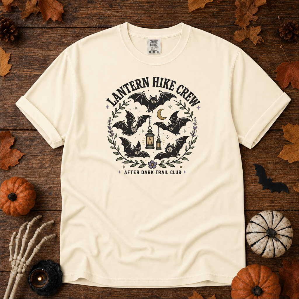 Ivory Comfort Colors t-shirt featuring a lantern glowing on a switchback trail under the moon, Trail & Ember Co.