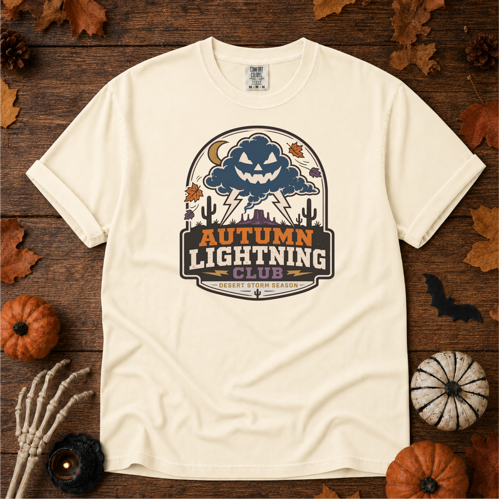 Ivory Comfort Colors t-shirt featuring lightning splitting the sky over a lone saguaro with storm clouds rolling across the desert, Trail & Ember Co.