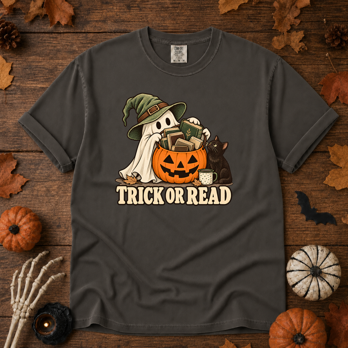 Trick or Read Halloween book lover t-shirt in Pepper - ghost in a witch hat with a pumpkin bucket full of books and a black cat, on garment-dyed Comfort Colors cotton