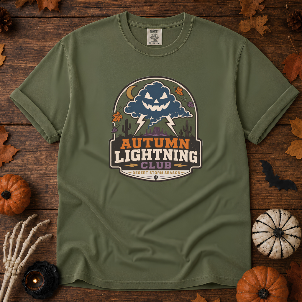 Sage Comfort Colors t-shirt featuring lightning splitting the sky over a lone saguaro with storm clouds rolling across the desert, Trail & Ember Co.