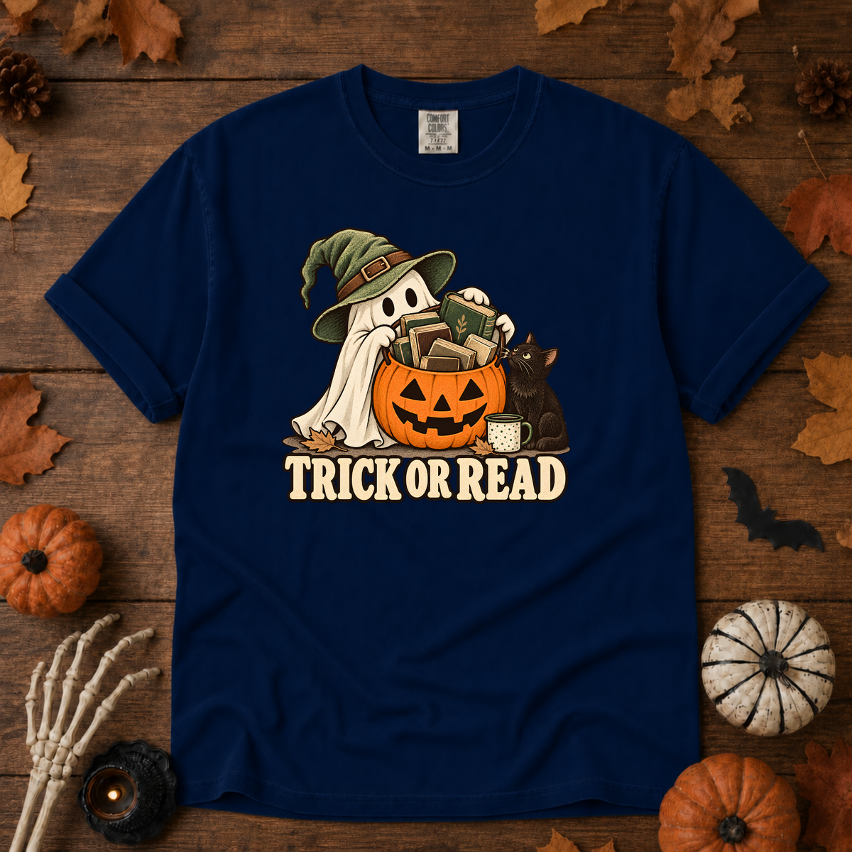 Trick or Read Halloween book lover t-shirt in True Navy - ghost in a witch hat with a pumpkin bucket full of books and a black cat, on garment-dyed Comfort Colors cotton