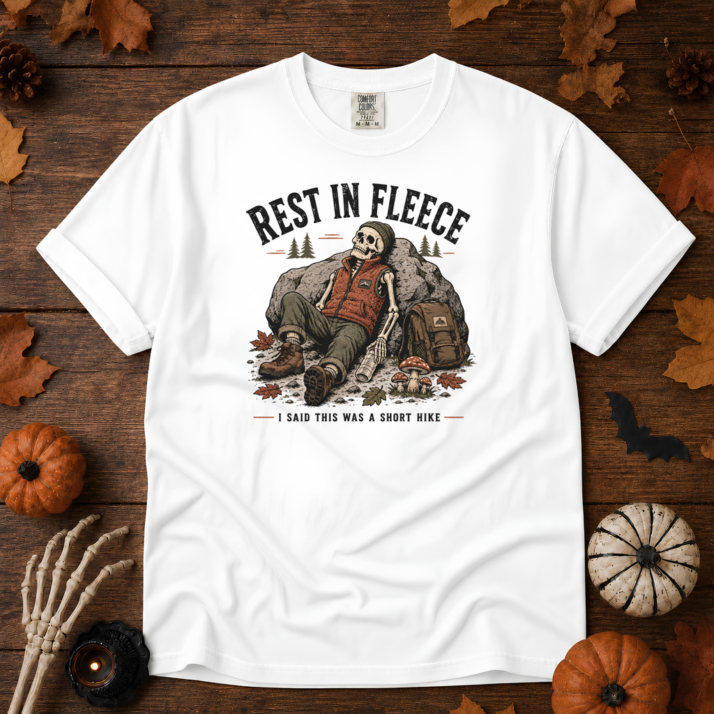 White Comfort Colors t-shirt featuring a skeleton wrapped head to rib in fleece, propped against a lantern, Trail & Ember Co.