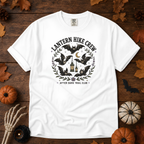 White Comfort Colors t-shirt featuring a lantern glowing on a switchback trail under the moon, Trail & Ember Co.
