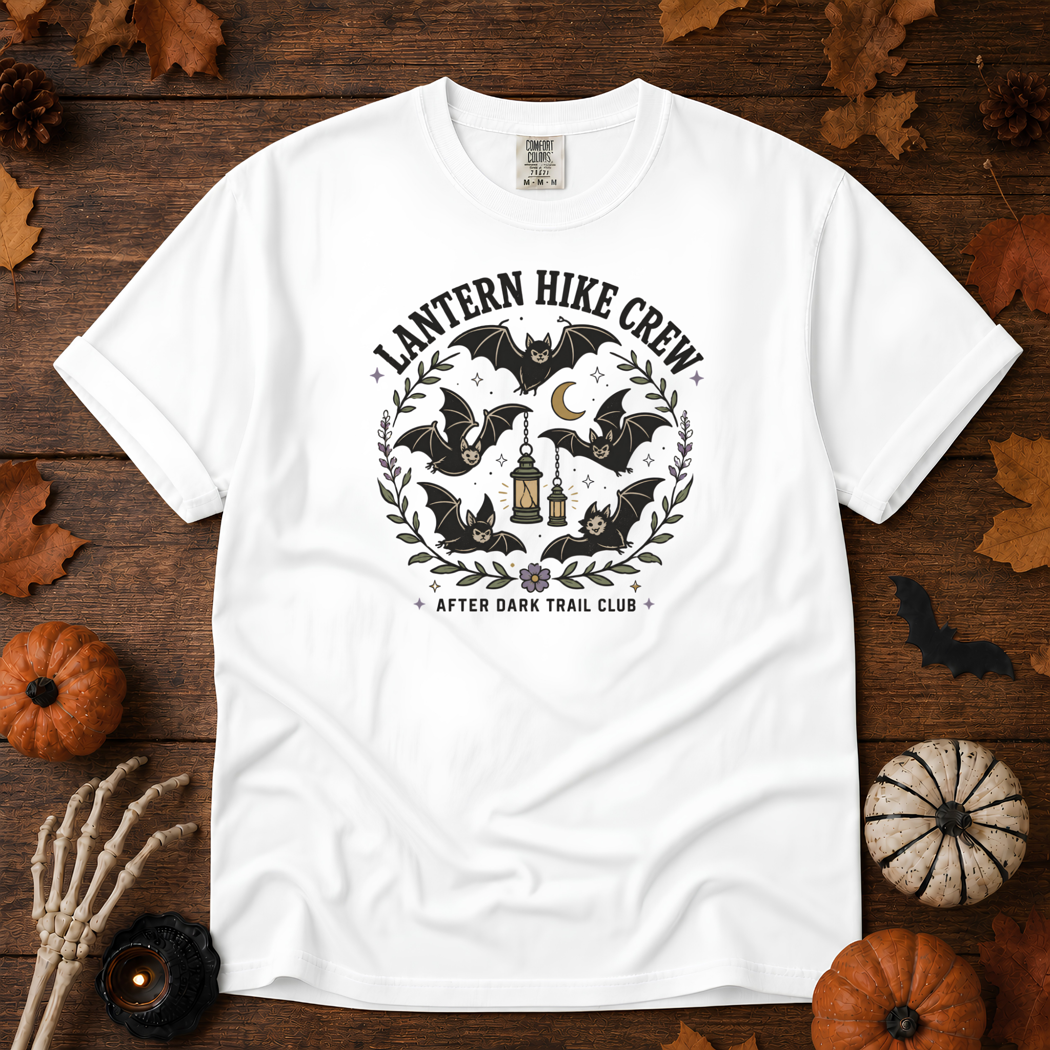 White Comfort Colors t-shirt featuring a lantern glowing on a switchback trail under the moon, Trail & Ember Co.