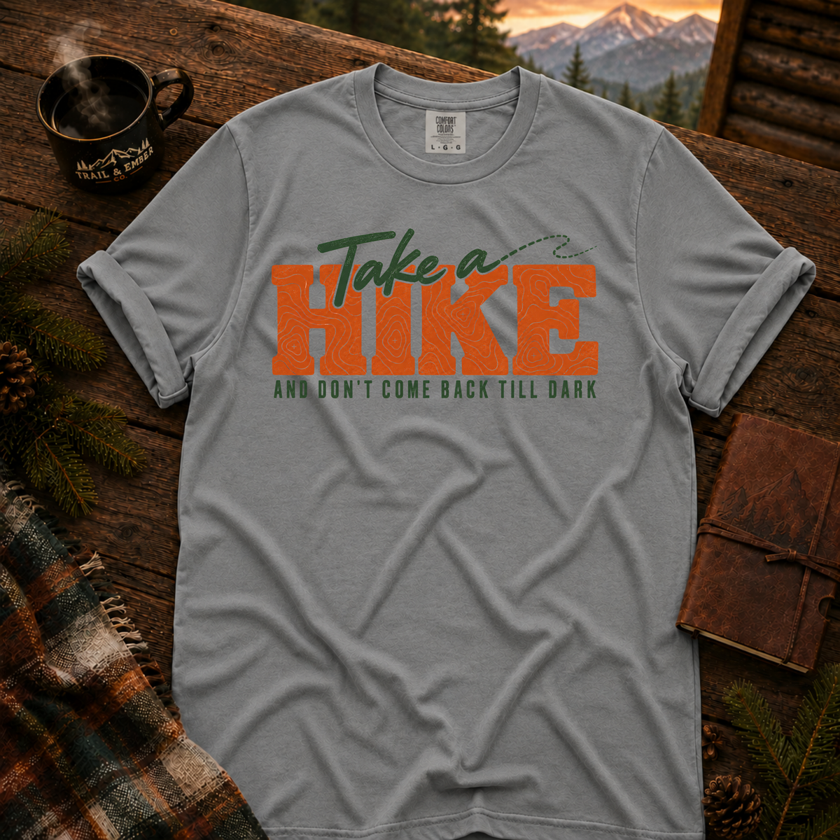 Grey Comfort Colors T-shirt with Take a Hike topo lettering and And Don't Come Back Till Dark slogan.