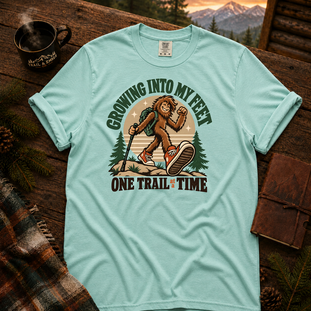 Chalky Mint Comfort Colors T-shirt with Teen Bigfoot hiking in orange sneakers with Growing Into My Feet lettering.
