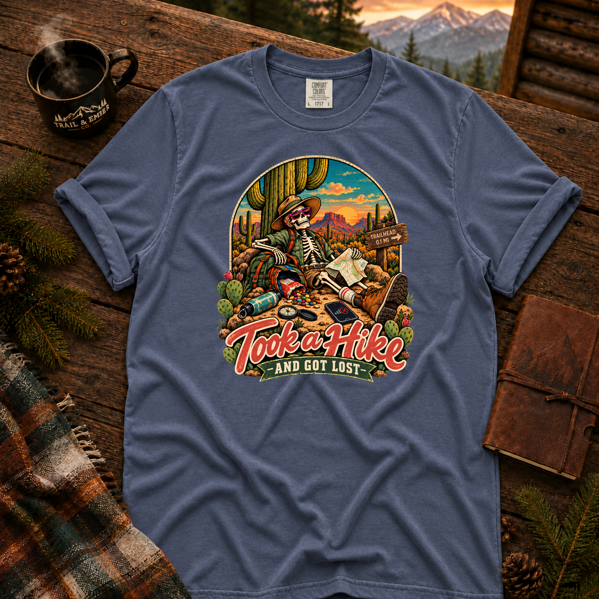 China Blue Comfort Colors T-shirt with Took a Hike and Got Lost skeleton resting beside a cactus with a map.