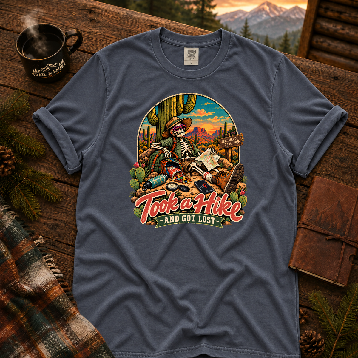 Midnight Comfort Colors T-shirt with Took a Hike and Got Lost skeleton resting beside a cactus with a map.