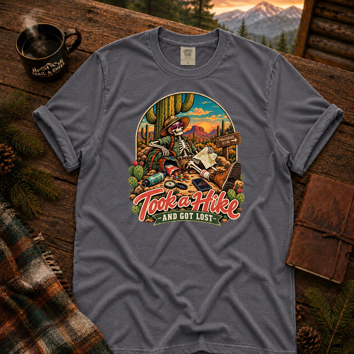 Navy Comfort Colors T-shirt with Took a Hike and Got Lost skeleton resting beside a cactus with a map.