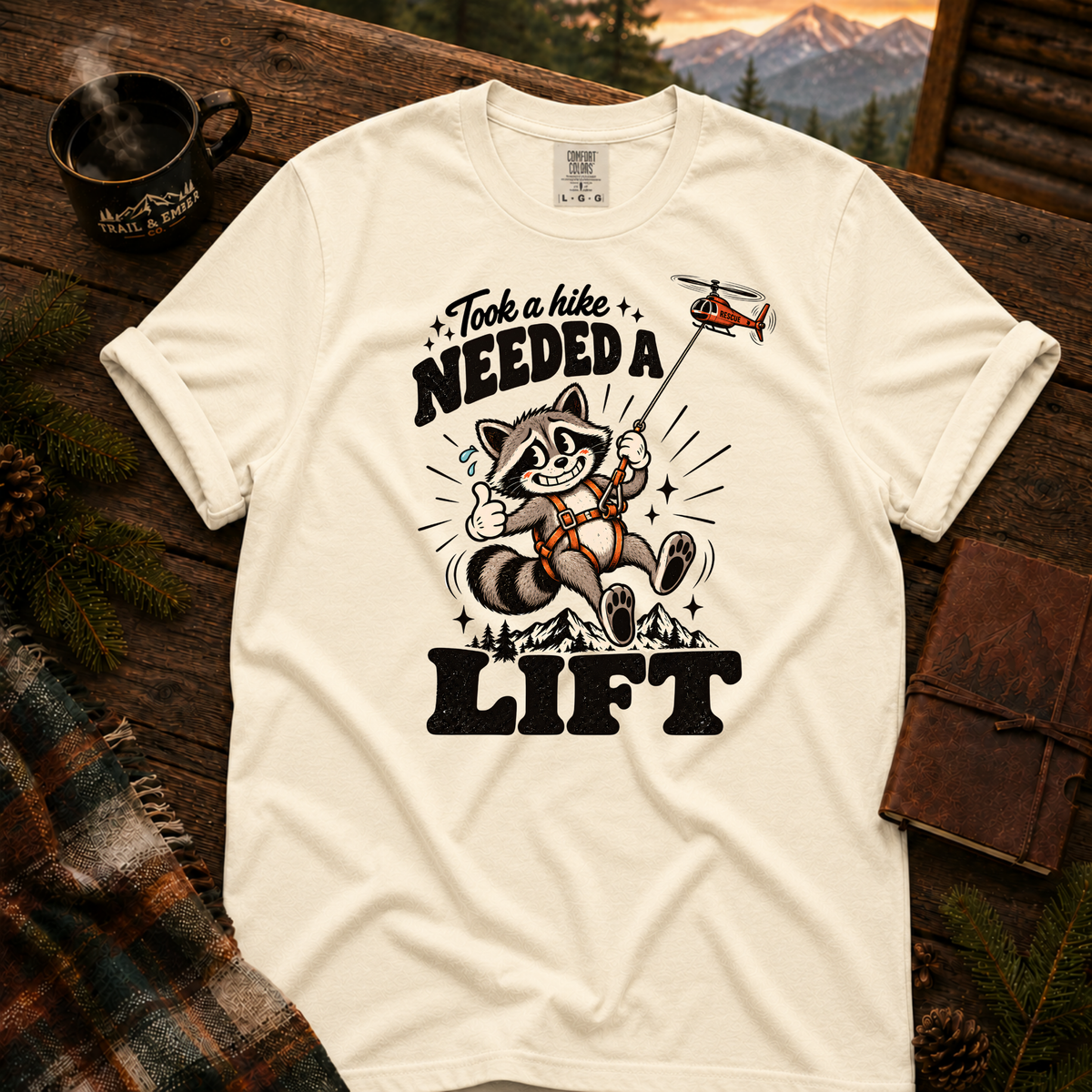 Ivory Comfort Colors T-shirt with Took a Hike, Needed a Lift raccoon and rescue helicopter design.